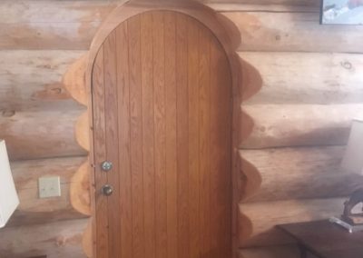rounded door on handcrafted log home